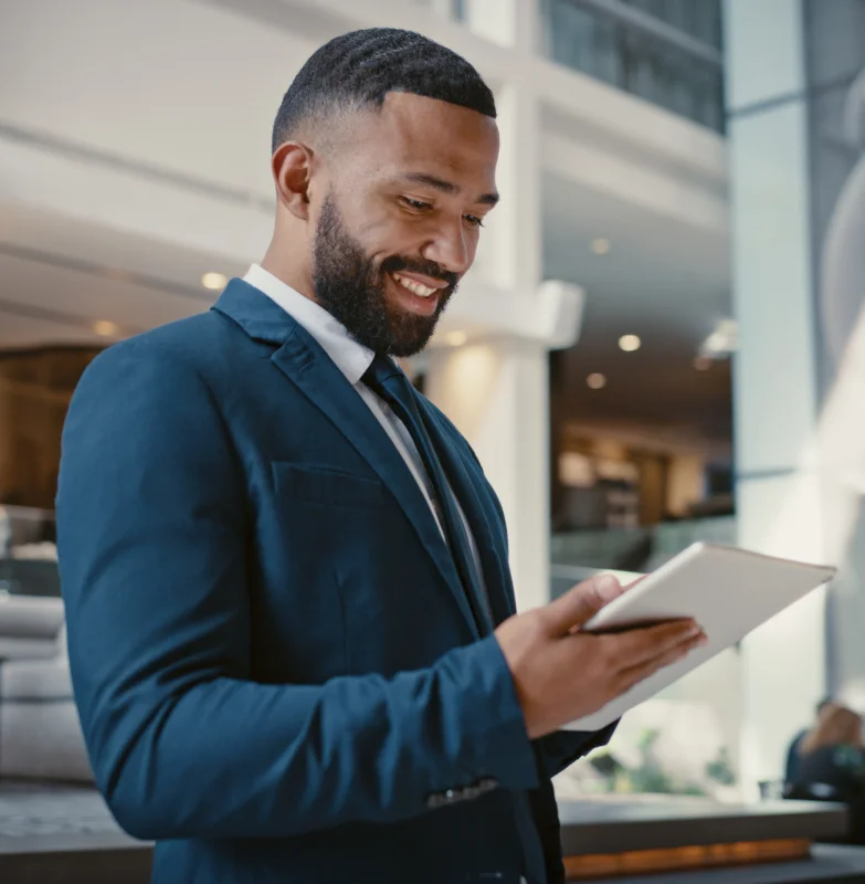 A Risk Manager in a suit is holding a tablet